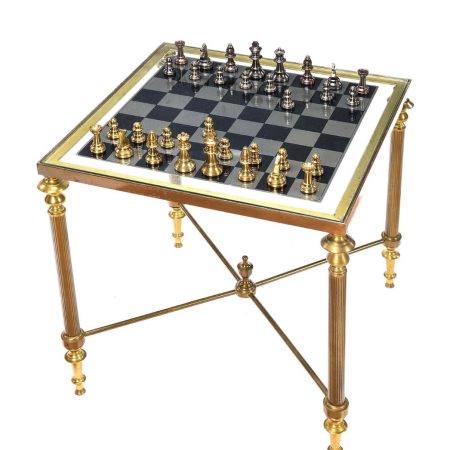 BRASS & GLASS CHESS TABLE. RAISED ON FLUTED LEGS. COMPLETE WITH CHESS PIECES.